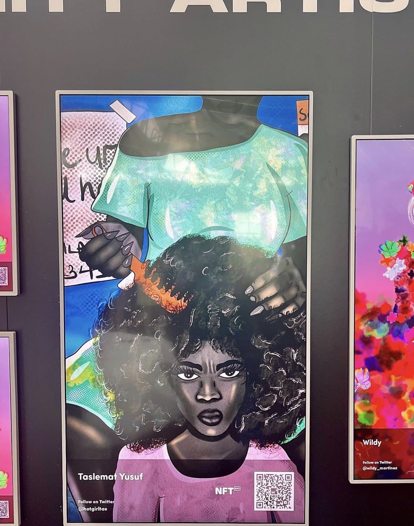The hair-combing artwork on display at an NFT exhibition, credited to Taslemat Yusuf