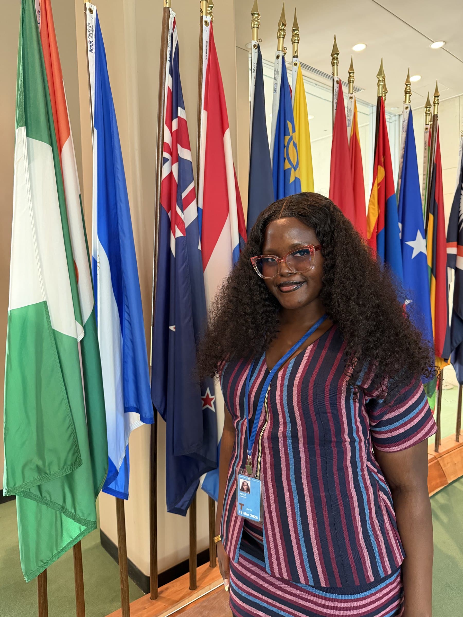 Taslemat Yusuf at the UN flag wall wearing CSW70 pass